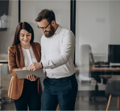 Two people reviewing a tablet
